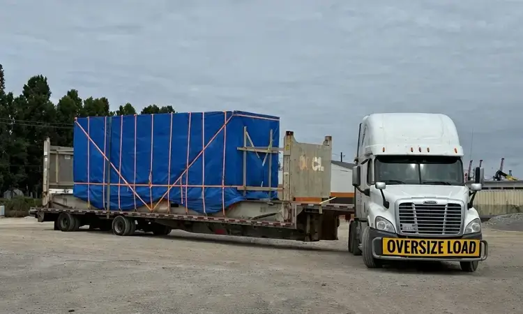 Heavy haul: oversize machinery on an open-deck trailer